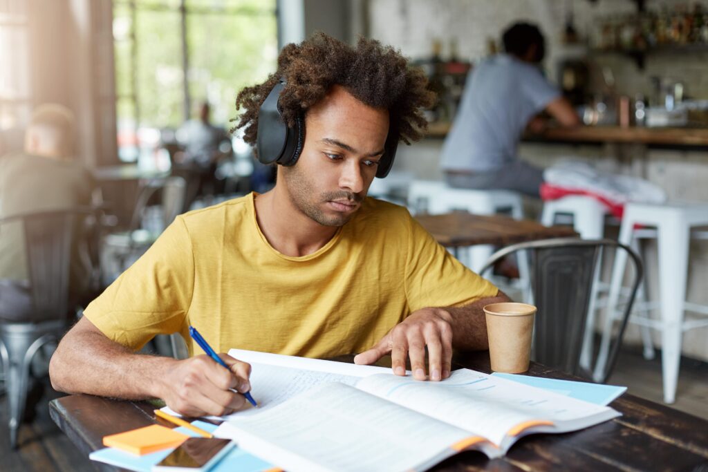 a law student writing his law assignment with the help of guidance